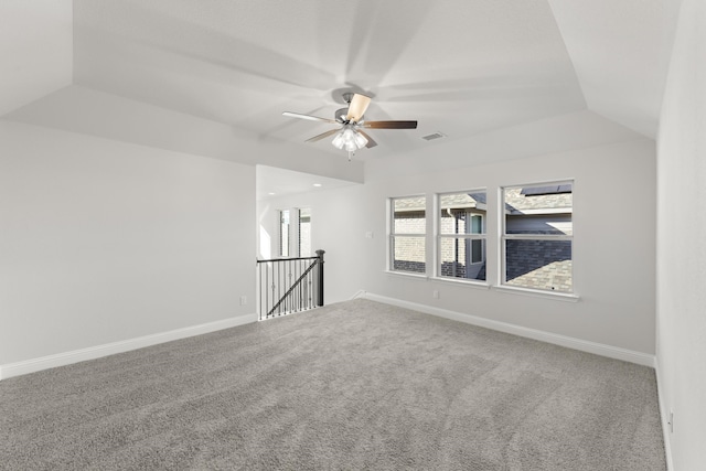 empty room featuring ceiling fan, carpet flooring, and lofted ceiling