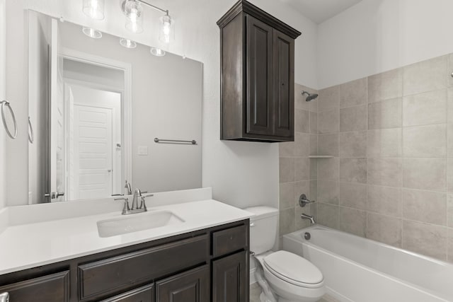 full bathroom with toilet, vanity, and tiled shower / bath