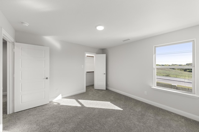 unfurnished bedroom featuring carpet floors and a closet