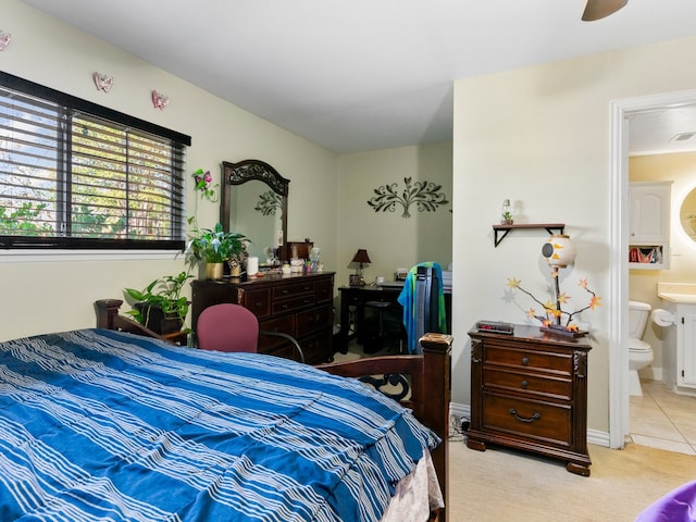 carpeted bedroom featuring ensuite bathroom and ceiling fan