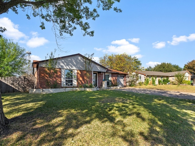 ranch-style home with a front yard and a garage