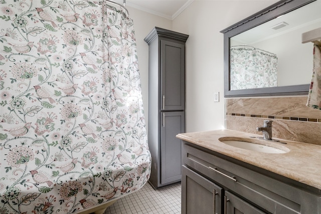 bathroom with tile patterned flooring, vanity, decorative backsplash, and crown molding