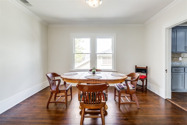 dining space featuring dark hardwood / wood-style flooring and ornamental molding