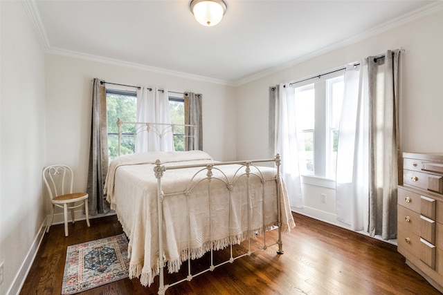 bedroom with dark hardwood / wood-style flooring and crown molding