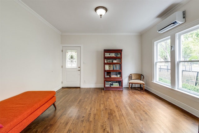 unfurnished room featuring a wall unit AC, plenty of natural light, and wood-type flooring