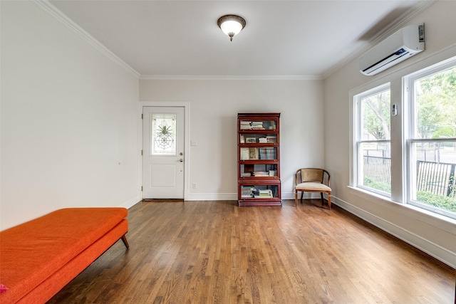 726 S Clinton Ave, Dallas, TX 75208 - sitting room featuring a wall unit AC, wood finished floors, healthy amount of natural light, ornamental molding, and baseboards