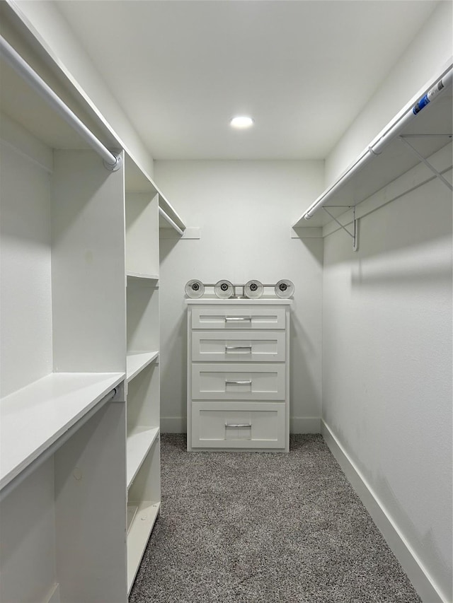 spacious closet featuring dark carpet