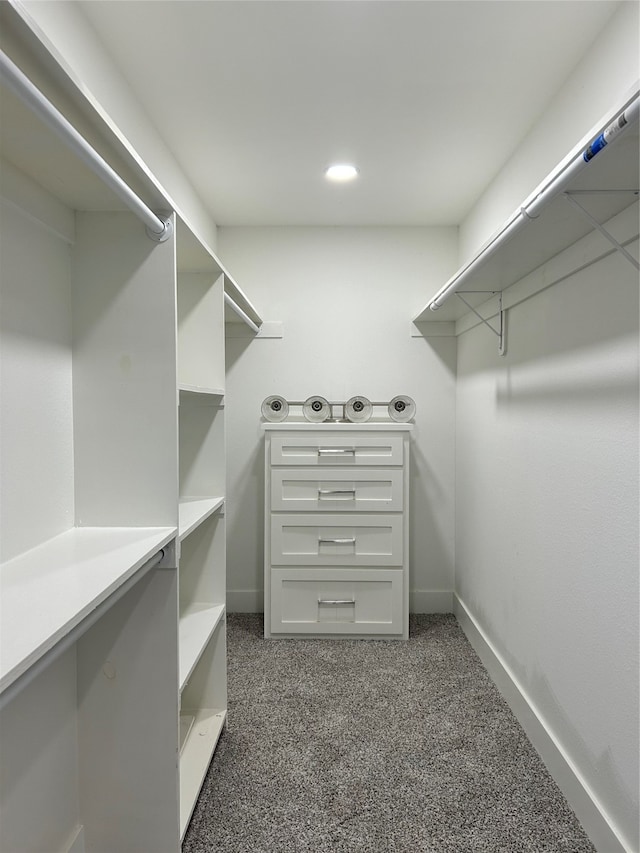 walk in closet featuring dark colored carpet