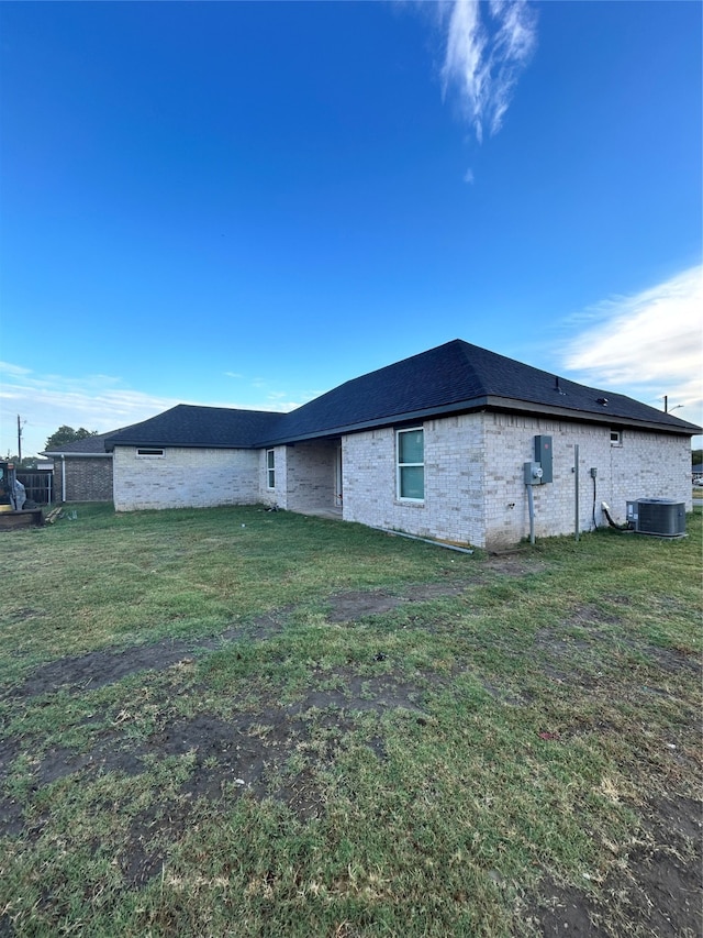 view of property exterior with a yard and cooling unit