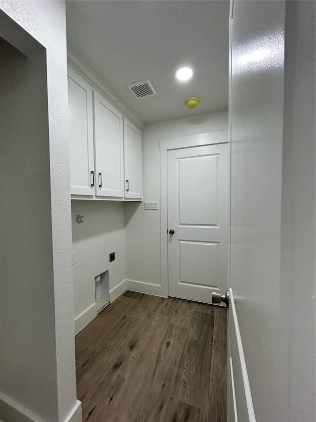 laundry area with cabinet space, baseboards, visible vents, dark wood-style flooring, and electric dryer hookup