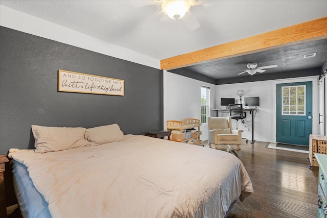 bedroom featuring ceiling fan, a textured ceiling, beamed ceiling, and dark hardwood / wood-style flooring