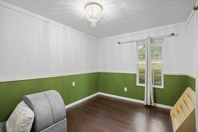 sitting room featuring a textured ceiling and dark hardwood / wood-style flooring