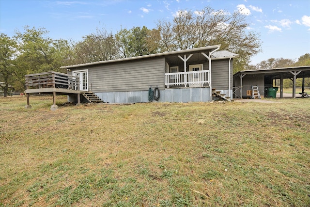 view of front facade with a carport, a front yard, and a deck