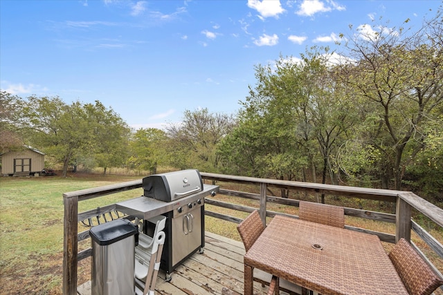 deck with a storage shed and a lawn