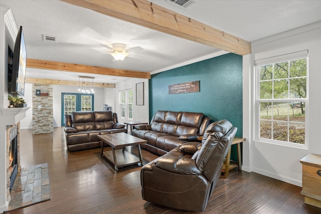 living room with beamed ceiling, dark wood-type flooring, a healthy amount of sunlight, and ceiling fan