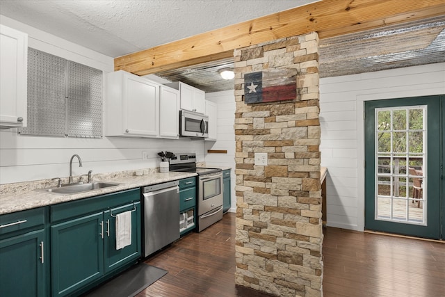 kitchen featuring white cabinetry, stainless steel appliances, dark wood-type flooring, and sink