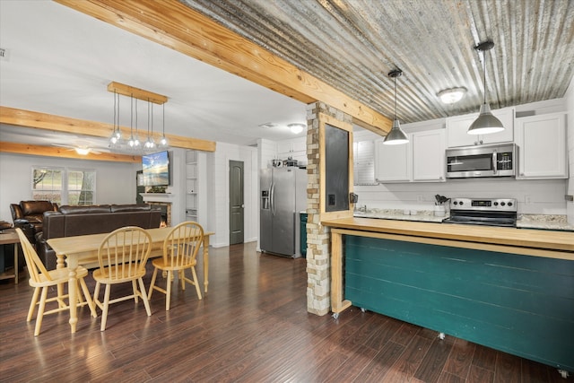 kitchen featuring white cabinetry, stainless steel appliances, pendant lighting, and dark hardwood / wood-style flooring