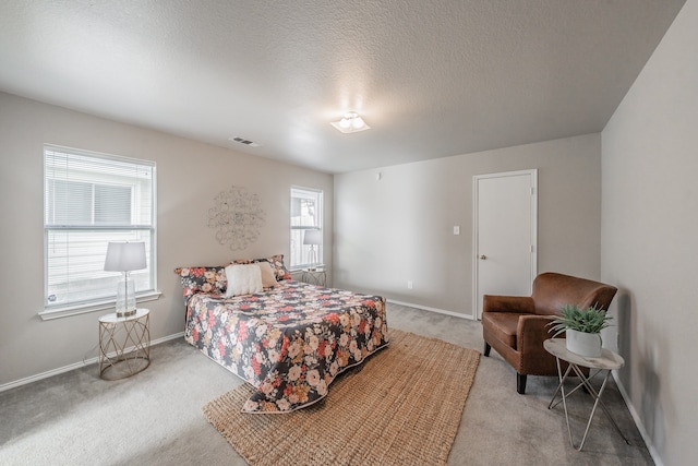 carpeted bedroom featuring a textured ceiling