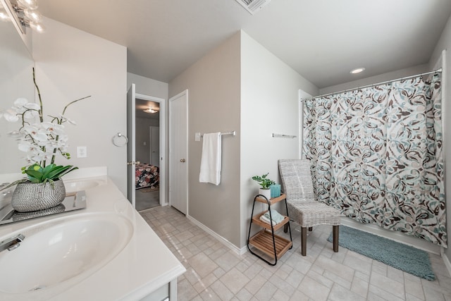 bathroom featuring vanity and shower / bath combo