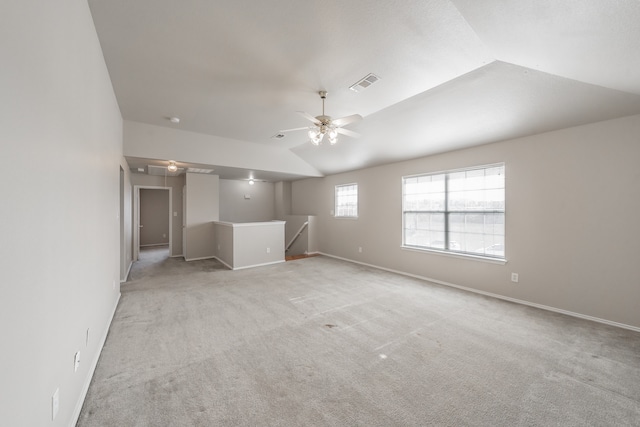 empty room featuring ceiling fan, light colored carpet, and lofted ceiling