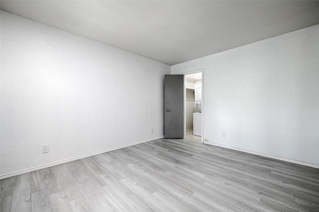 spare room with light hardwood / wood-style flooring