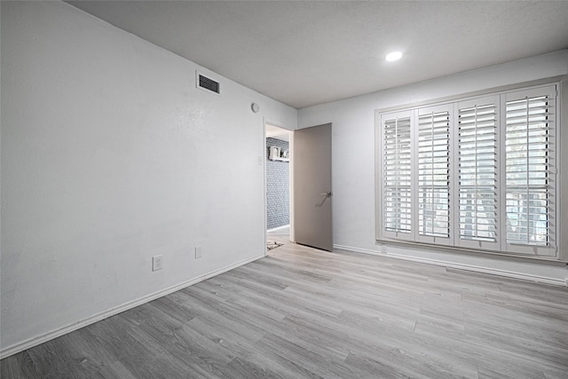 unfurnished room featuring light hardwood / wood-style flooring