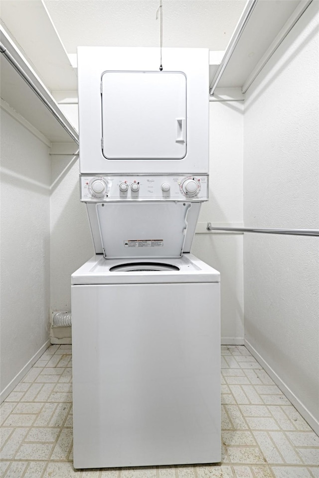 laundry area featuring stacked washing maching and dryer