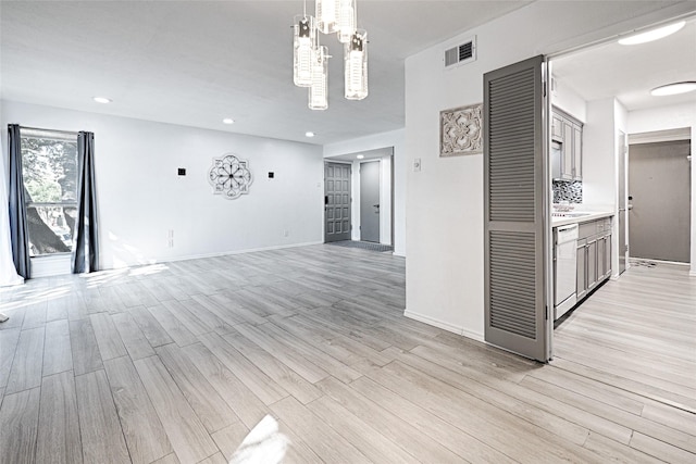 interior space with an inviting chandelier and light wood-type flooring