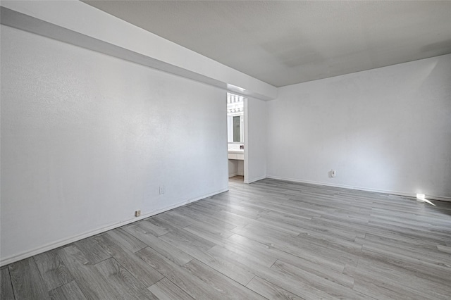 spare room featuring light hardwood / wood-style flooring