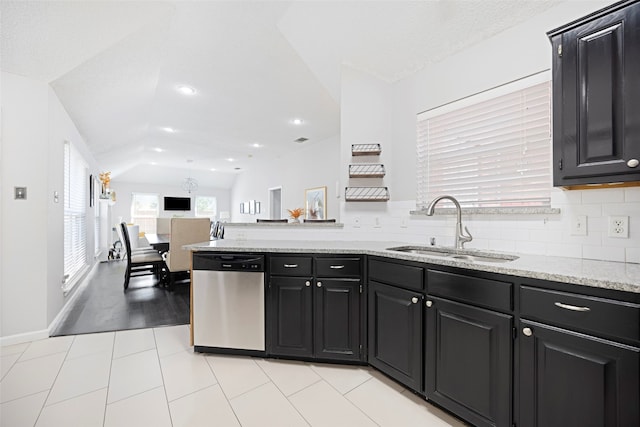 kitchen with light tile patterned flooring, backsplash, sink, dishwasher, and lofted ceiling