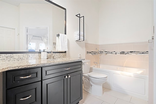 bathroom featuring a tub to relax in, vanity, tile patterned floors, toilet, and tile walls