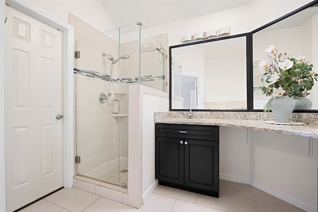 bathroom with vanity, a shower with shower door, tile patterned flooring, and lofted ceiling