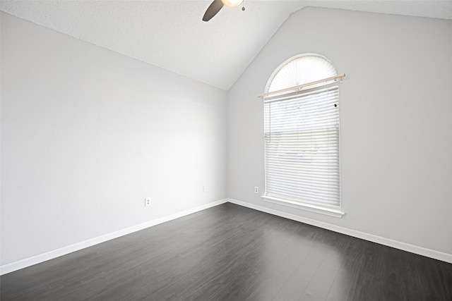 empty room with ceiling fan, dark hardwood / wood-style floors, a textured ceiling, and lofted ceiling