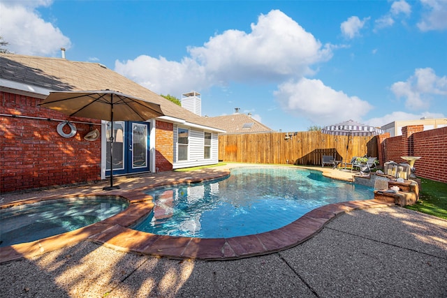 view of pool featuring an in ground hot tub and a patio area