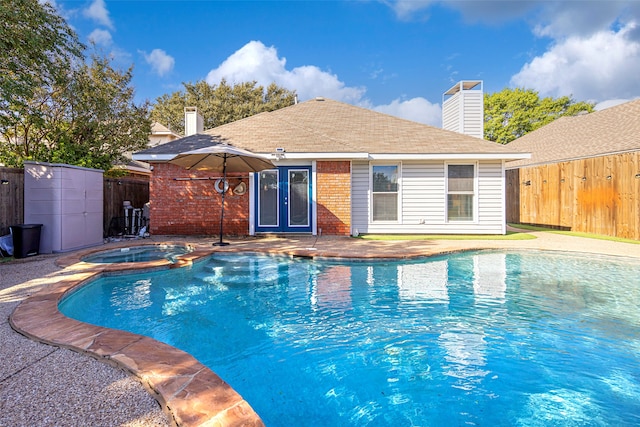 view of swimming pool with a patio and an in ground hot tub