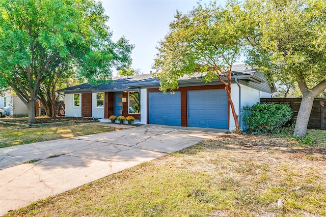 ranch-style home featuring a front yard and a garage