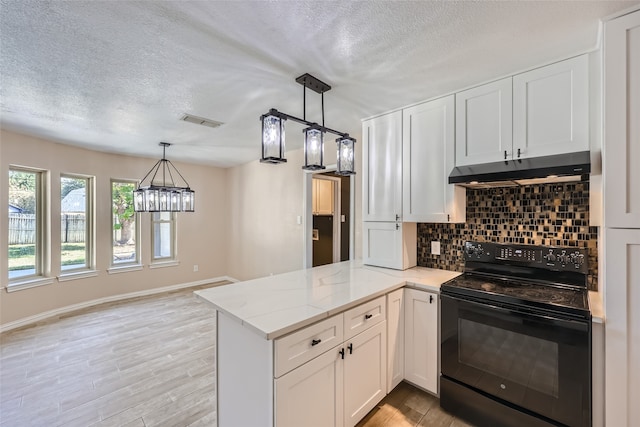 kitchen featuring black range with electric cooktop, tasteful backsplash, and white cabinetry