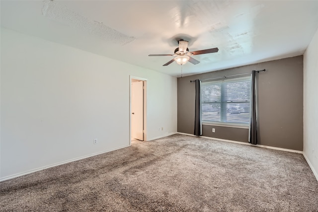 empty room featuring ceiling fan and carpet floors