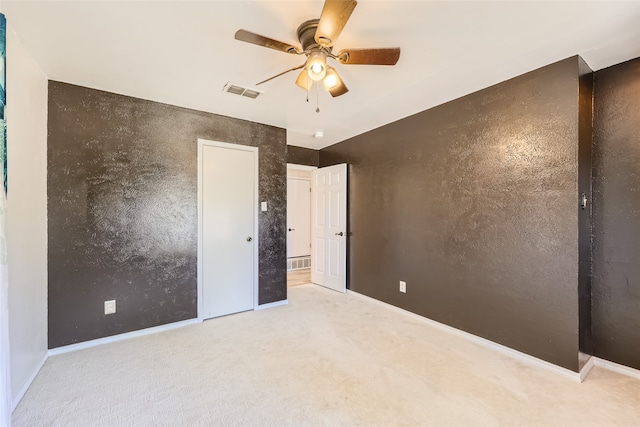 unfurnished bedroom with ceiling fan and light carpet