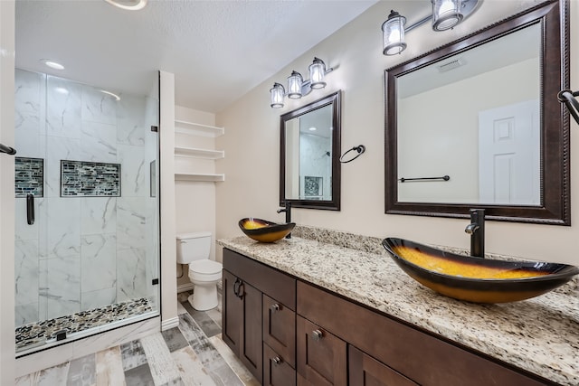 bathroom featuring hardwood / wood-style floors, vanity, toilet, and a shower with shower door