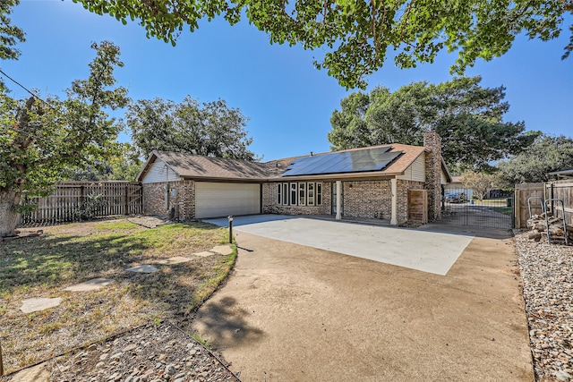 view of front of home with a garage and solar panels