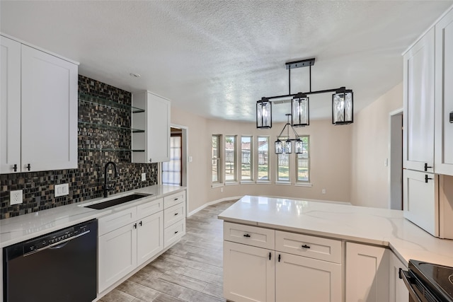 kitchen with dishwasher, sink, light hardwood / wood-style flooring, light stone counters, and white cabinetry