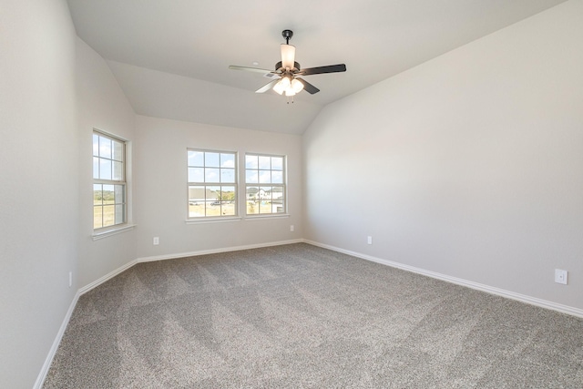 carpeted empty room with baseboards, a ceiling fan, and lofted ceiling