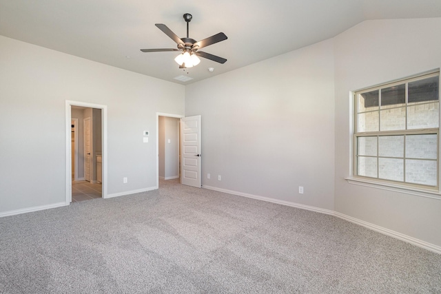 unfurnished bedroom with carpet floors, lofted ceiling, baseboards, ceiling fan, and connected bathroom