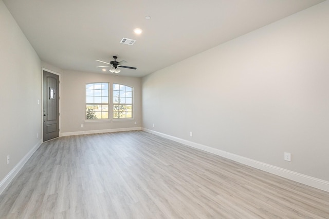 unfurnished room featuring baseboards, a ceiling fan, light wood-type flooring, and visible vents