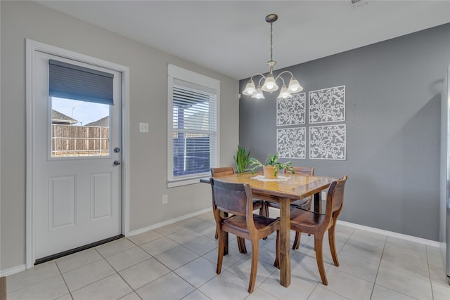 dining space featuring an inviting chandelier and light tile patterned floors