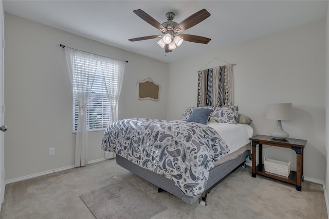 bedroom with ceiling fan and light carpet