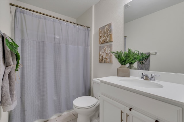 bathroom with vanity, toilet, walk in shower, and tile patterned flooring