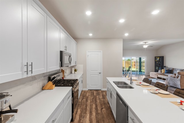 kitchen featuring appliances with stainless steel finishes, white cabinetry, sink, and dark hardwood / wood-style floors