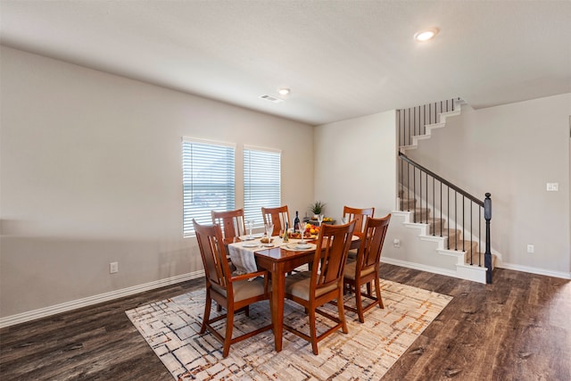 dining space with dark hardwood / wood-style floors